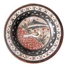 a decorative bowl with birds and flowers painted on the side in black, red, white and orange colors