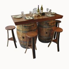 a wooden table topped with two wine barrels and three stools next to each other