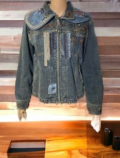 a denim jacket hanging on a wooden wall