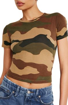 Soft and semisheer, this figure-hugging cotton T-shirt is easy to style up or down with its classic crewneck and slightly cropped length. 21" length (size Medium) Crewneck Short sleeves 100% cotton Machine wash, tumble dry Imported Black Owned/Founded American Shorts, Lightweight Tops, Faux Leather Pants, Good American, Camo Print, Workout Tee, Body Positivity, Short Tops, Cotton T Shirt