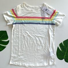 Fabric: Pure Cotton Jersey Fabric Fit: Classic, Comfortable Regular Fit Printed Multi-Colored Stripes With Roxy Print On Chest Trendy White Top, Trendy White Top For Playwear, Multicolor Spring T-shirt For Play, Playful White Top With Rainbow Print, Playful Cotton Tops With Rainbow Print, Playful Cotton Top With Rainbow Print, Trendy Multicolor Tops For Playwear, Fun White Top With Rainbow Print, Fun White Tops With Rainbow Print