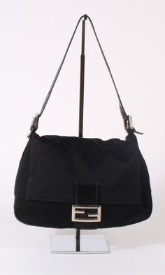 OR 4 interest-free installments of $187.50 USD by Vintage Fendi shoulder bag in black cotton canvas. Top flap with black leather closure and silver logo hardware. Magnetic button closure. One large interior compartment with one inner zip pocket Dimensions (inches): 11 W x 7 H x 4 W Condition: Excellent Black Vintage Bag, Black Fendi Bag, Fendi Baguette Vintage, Fendi Vintage Bag, Vintage Fendi Baguette, Vintage Fendi Bag, Fendi Baguette Bag, Japan Shopping, Fendi Shoulder Bag