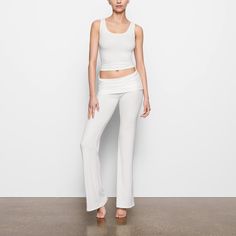 This soft, smooth, and stretchy ribbed pant features a throwback-inspired flare with a foldover waistband. Fitted Ribbed Wide-leg Pants, Fitted Wide-leg Ribbed Pants, Ribbed Flare Pants For Loungewear, Flare Ribbed Pants For Loungewear, Fitted Ribbed Athleisure Pants, Fitted Ribbed Pants For Athleisure, Spring Flare Yoga Pants For Loungewear, Chic Flare Pants For Loungewear, Fitted Wide Leg Loungewear Pants