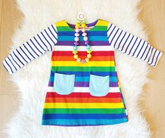 Rainbow Striped Pocket Long Sleeve Dress - ARIA KIDS Multicolor Cotton School Dress, Fun Rainbow Dress For Playtime, Fun Rainbow Playtime Dress, Long Sleeve Blue Birthday Dress, Playful Striped Dress For Playdate, Playful Striped Dresses For Playdate, Playful Multicolor Long Sleeve Dress, Playful Long Sleeve Dress For Playdate, Playful Multicolor Dresses For School