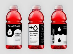 three bottles of vitamin water are shown in this image, one is red and the other is black