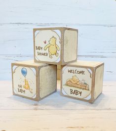 three wooden blocks with winnie the pooh and baby shower pictures on them