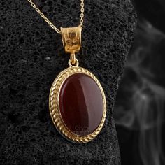 This stunning necklace features a beautiful oval-shaped Yemen Agate stone, known as Aqeeq, renowned for its unique red hues and captivating patterns. Each stone is carefully handpicked to ensure its authenticity and quality. The pendant is crafted with precision and set in high-quality sterling silver, adding a touch of elegance to the overall design. The combination of the vibrant red Agate stone and the sterling silver creates a captivating contrast, making this necklace a true statement piece Luxury Red Amulet Necklace, Luxury Red Cabochon Jewelry, Luxury Red Oval Pendant Jewelry, Traditional Oval Cabochon Necklaces, Traditional Oval Cabochon Necklace, Agate Oval Pendant Necklace For Gifts, Elegant Carnelian Oval Pendant Jewelry, Formal Oval Agate Necklace, Spiritual Oval Agate Necklace