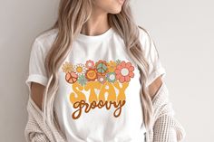 Very cute retro Stay groovy T-shirt! This will be perfect if you are looking for Hippie/boho style and great gift for family and friends! This classic unisex jersey short sleeve tee fits like a well-loved favorite. Soft cotton and quality print make users fall in love with it over and over again. These t-shirts have-ribbed knit collars to bolster shaping. The shoulders have taping for better fit over time. Dual side seams hold the garment's shape for longer.  .: 100% Airlume combed and ringspun White Hippie T-shirt For Spring, Spring Hippie Retro Print T-shirt, White T-shirt With Retro Print For Spring, Retro Cotton T-shirt With Floral Print, White Retro T-shirt With Floral Print, Groovy Short Sleeve T-shirt For Spring, Vintage White T-shirt With Floral Print, Retro Printed T-shirt For Spring, White Floral Print Hippie Top