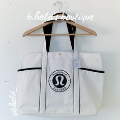 Description: Lululemon Daily Multi-Pocket Tote *Canvas Bag In Natural/Black (Nat/Blk). Light Cream/Tan Color With Black Trim And A Black Lululemon Logo. Older Version From May 2023. Designed For "On The Move." Water-Repellent Fabric. 20l Volume. Snap Closure. Easy-Access Exterior Pocket For Essentials. Interior Pocket For Small Items. Exterior Drop-In Pockets Have Plenty Of Room For A Water Bottle, Snacks, And Books. Stands Up On Its Own! Sold Out. Material: Body: 100% Cotton Size: One Size Dime Sporty White Bag With Pockets, Everyday White Bags With Side Pockets, White Everyday Bags With Side Pockets, White Tote Gym Bag, White Bags With Functional Pockets For Everyday Use, Sporty Everyday Bag With Side Pockets, Lululemon Bags, Utility Bag, Black Lululemon