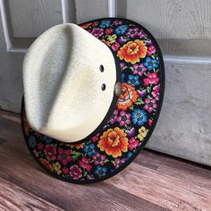 This beautiful Mexican Sombrero has would be perfect to add that special touch to any outfit. MADE IN MEXICO By: Mexican Artisans For: Women Size: Medium 23' Color: off-white | multi Details: Material: palm straw Fabric canvas design Bottom black suede Inner elastic band Contact us for more details PLEASE READ BEFORE PURCHASE: The picture is an ACCURATE REPRESENTATION.Colors in the pictures may vary a little by effects of light. Each product is handmade from Mexico causing differentiation and mi White Toquilla Straw Panama Hat For Festivals, Wide Brim Beach Hat For Cinco De Mayo, Wide Brim Hats For Beach And Cinco De Mayo, Wide Brim Straw Hat For Cinco De Mayo Festival, Multicolor Brimmed Panama Hat In Toquilla Straw, Brimmed Beach Hats For Cinco De Mayo, Multicolor Hats For Vacation And Cinco De Mayo, Adjustable Straw Hat For Beach And Cinco De Mayo, White Toquilla Straw Hat For Festival