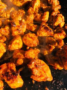 the food is being cooked on the grill with steam coming from it's sides