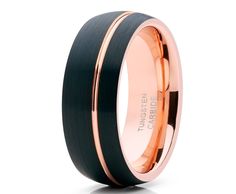 a black and rose gold wedding ring with an inlay on the inside of it