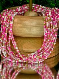 **Please allow up to 5-7 business days for processing time for Waistbeads, Free US Shipping for orders over $75 ** Our stunning Barbie Waistbeads, are perfect for adding a touch of elegance and tradition to your style. These waistbeads feature a beautiful pink colors, accented with splashes of gold beads throughout. Crafted with high-quality 8/0 and 6/0 glass beads, they offer both durability and beauty. Designed to fit most with a standard length of 60", these traditional tie-on waistbeads allo Pink And Gold Waist Beads, Pink Hand-strung Jewelry For Festival, Hand-strung Pink Jewelry For Festivals, Pink Hand-strung Beaded Necklaces For Festival, Festival Pink Hand-strung Beaded Necklaces, Festival Hand-strung Pink Beaded Necklaces, Hand-strung Pink Beads For Festivals, Pink Multi-strand Jewelry With Polished Beads, Spiritual Pink Spacer Beads