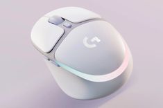 a white computer mouse sitting on top of a purple surface with light coming from it's side