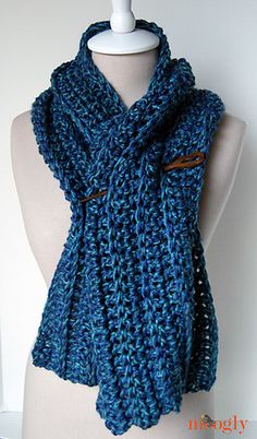 a mannequin wearing a blue knitted scarf