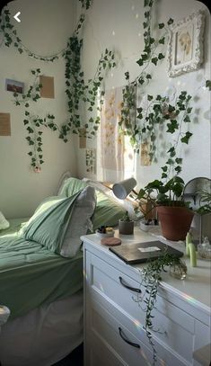 the bedroom is decorated with plants and pictures