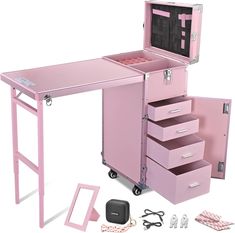 a pink vanity with drawers and accessories