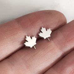 This makes a great gift for any Canadian, or anyone with Canadian roots. The maple leaf is the national symbol for Canada and these small delicate earrings are perfect to wear everyday. The maple leaf is 8mm high x 7mm wide and 1mm thick. It is made from sterling silver and the post and ear backs are also sterling silver. Please purchase these from my new Etsy Shop and get 10% off your order with code GIMME10: https://www.etsy.com/LightSideBoutique/listing/882198937/maple-leaf-stud-earrings-in-sterling All of my jewelry comes in a gift box, so it's ready for gift giving to friends or family - or a little treat just for you! If you have any questions, please email me! I'd love to speak with you! Shipping is free within the US, or upgrade to Priority Mail or Priority Mail Express! Get 10% of Canadian Gifts, Silver Maple Leaf, Alternative Wedding Bands, Cube Necklace, Bubble Necklaces, Silver Necklace Statement, Small Earrings Studs, Leaf Jewelry, Natural Gifts