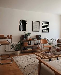 a living room filled with furniture and pictures on the wall