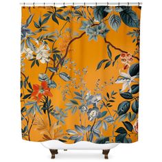 an orange shower curtain with flowers and leaves on the outside, against a white background