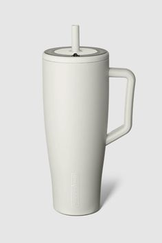 a white coffee cup with a lid and handle