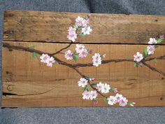 a piece of wood with flowers painted on it