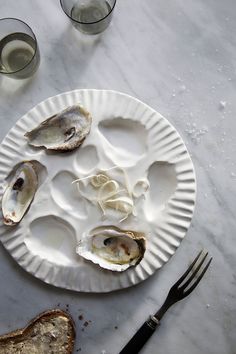 an empty plate with oysters on it