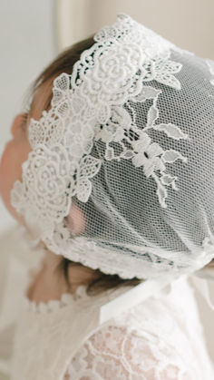 Juliette Lace Bonnet | A sweet rose lace frames her face and silk ribbon ties to secure the bonnet comfortably. Elegant Wedding Bonnet, One Size, White Fitted Bonnet For Baptism, Adjustable Cotton Bonnet With Lace Trim, White Adjustable Lace Bonnet, Lace Baby Bonnet, Lace Bonnet, Rose Lace, Ribbon Tie, Christening Gowns