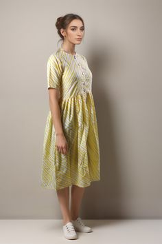 Elevate your summer wardrobe with the Tiska New York Yellow Patterned Cotton Casual Short Sleeve Summer Midi Dress. This knee-length dress features a chic and modest fit-and-flare style, perfect for a casual day out or dressing up for an elegant occasion. Patterned design in a beautiful yellow colored dress Half sleeves style that is perfect for warmer seasons Crafted from 100% cotton material, making it comfortable and breathable Hand wash only for easy care instructions Made in India with high-quality craftsmanship This dress is versatile enough to wear during spring and summer months. Its casual yet boho-chic style makes it suitable to wear on any occasion. It's sweet, minimalist design makes it the perfect choice if you're looking to show off your elegant sense of style while remaining Cotton A-line Dress For Day Out, Cotton Fit And Flare Mini Dress, Cotton Fit And Flare Mini Dress Knee-length, Cotton Fit And Flare Knee-length Mini Dress, Summer A-line Fit And Flare Midi Dress, Fit And Flare A-line Midi Dress For Summer, Cotton Fit And Flare Dress For Daywear, Fitted Midi-length Cotton Sundress, Cotton Midi Knee-length Dress For Day Out