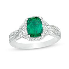 Take her breath away with this exquisite fashion ring. Crafted in sterling silver, this pleasing design features an 8.0 x 6.0mm cushion-cut lab-created verdant-green emerald wrapped in a sparkling frame of petite lab-created white sapphires. The multi-row shank shimmers with elegantly braided created sapphire-lined and polished ribbons. Buffed to a brilliant lustre, this choice captures her graceful style. Cushion Cut Emerald Ring For Formal Occasions, Elegant Square Cut Jewelry With Accent Stones, Elegant Asscher Cut Emerald Ring In Sterling Silver, Green Cushion Cut Diamond Jewelry, Green Cushion Cut Jewelry For Formal Occasions, Formal Green Cushion Cut Jewelry, Elegant Sterling Silver Emerald Ring With Rectangular Stone, Silver Cushion Cut Ring With May Birthstone, Elegant Sterling Silver Emerald Ring With Gemstone Accents