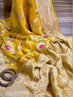 Update! - Zynah covered by LBB - https://lbb.in/bangalore/zynah-designs-handloom-sarees/ Banarasi pure georgette woven saree, decorated with intricate design. Their special characteristics are Mughal inspired designs such as intricate interwining floral and foliate motifs. Other features are gold/Silver work, compact weaving, figures with small details, metallic visual effects, pallus, jal (a net like pattern). Depending on the intricacy of its designs and patterns, a saree can take from 15 days Benares Georgette Sarees, Semi-stitched Banarasi Silk Blouse Piece With Pallu, Yellow Georgette Choli With Chikankari Embroidery, Yellow Choli With Chikankari Embroidery, Semi-stitched Bollywood Blouse Piece In Jamawar, Unstitched Gold Georgette Blouse Piece, Unstitched Blouse Anarkali Set In Georgette For Diwali, Traditional Yellow Dupatta For Designer Wear, Festive Anarkali Jamawar Blouse Piece