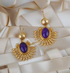 We produce our  jewelery in Istanbul. We use semi precious gemstones and brass covered with 18k-24k  gold. Their nature may cause gemstones to be in different shapes and color. Do not forget to explore more pieces using the link below. https://www.etsy.com/shop/FndJewelry  THANK YOU🤍 We are so grateful you have chosen FndJewelry. We love sharing happiness with you, it is only real when shared! Traditional Oval Yellow Gold Earrings, Hallmarked Drop Earrings For Celebration, 22k Gold Teardrop Jewelry Gift, Gold Fusion Jewelry With Gemstones, Oval Yellow Gold Brass Earrings, Elegant 22k Gold Gemstone Earrings, Festive Teardrop Hallmarked Jewelry, Elegant Purple Jewelry For Festive Occasions, Handmade Temple Jewelry Drop Earrings