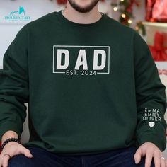 "❤️ Honor his journey into fatherhood with a retro-inspired \"Est. Dad\" embroidered sweatshirt, customized with his kids' names on the sleeve. A timeless piece that blends vintage charm with the personal significance of his most important role. This thoughtful gift wraps him in the warmth of his family's love, perfect for chilly days or relaxing evenings. Ideal for birthdays, holidays, or simply as a way to say \"thank you,\" this sweatshirt is a daily reminder of the love and respect his famil