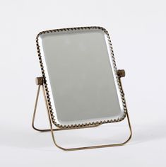 a mirror sitting on top of a metal stand