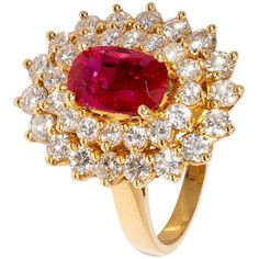 Perfect as a gift for someone with passion and style, this eye-catching ring features a stunning oval ruby in bright pinkish-red at its centre. Around it, a cluster of small white diamonds are arranged in a double halo, elevating the centre stone from its yellow gold mount. It’s a versatile piece; the top of the ring separates from the band and can be worn as a pendant (chain not supplied). Ring Size: UK - I, US - 4 1/2 Expensive Rings, Pinkish Red, Contemporary Ring, American Modern, Double Halo, No Heat, Fine Jewels, Pretty Rings, Diamond Cluster Ring