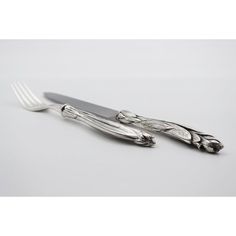 two forks and spoons sitting next to each other