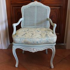 an old chair is sitting in front of a door