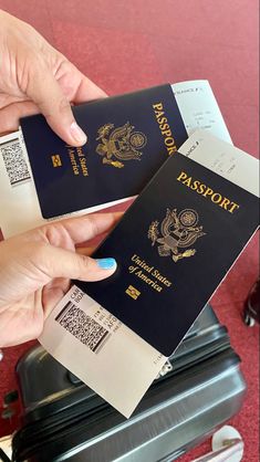 two people holding passports in their hands