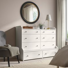 a bedroom scene with focus on the dresser and mirror