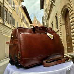 This Italian leather travel bag is expertly handcrafted in Florence, Italy, using the finest genuine leather. Designed for men seeking premium quality, luxury, and modern Italian fashion, this duffle bag with wheels allows you to travel with ease and sophistication. . Size: Height: 33 cm (12.99 inches) Width: 50 cm (19.69 inches) Depth: 24 cm (9.45 inches) . The story of this travel bag: In the heart of Italy, where the rich legacy of craftsmanship thrives, there existed a renowned workshop dedicated to creating exquisite travel accessories. Among their coveted collection were the handmade duffle bags, carefully crafted to cater to the needs of discerning travelers seeking both style and functionality. These duffle bags, designed specifically as men's travel gear, embodied the essence of I Luxury Brown Luggage With Leather Lining, Luxury Rectangular Luggage With Leather Lining, Luxury Leather Briefcase For Trip, Luxury Briefcase With Luggage Sleeve For Trip, Luxury Brown Briefcase For Overnight Trips, Elegant Brown Luggage For Daily Use, Luxury Briefcase For Overnight Trips, Luxury Brown Luggage For Business Trips, Classic Leather Briefcase For Trips