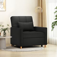 a living room with a black chair in it