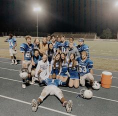 a group of young people standing on top of a football field next to each other