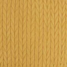 the texture of an upholstered fabric with wavy lines in yellow and brown colors