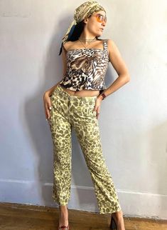 "Cult 90s Roberto Cavalli high-waisted jeans in an abstract animal print that resembles giraffe or leopard spots in a thick but soft denim, classic 5 pocket style, straight bootcut cut fit that hugs all the right places. There is a touch of lurex that gives an extremely subtle sparkle. Metal logo buttons and rivets; jeans have been hemmed up and can be taken down by about 1\". 98% cotton, 2% elasthan. From the Cavalli Jeans line. Made in Italy. Pre-loved but in very good condition.  Size marked is 30 or Fr 28. Model is a Fr 36 or Small. Please check measurements below for a precise fit. MEASUREMENTS: taken closed and flat, across. Double for waist,hips and/or chest. Please compare to a personal garment to ensure fit, as I do not accept returns unless the item has been misrepresented.  - Wa Trendy Fitted Tiger Print Bottoms, Fitted Tiger Print Trendy Bottoms, Fitted Tiger Print Summer Bottoms, Fitted Tiger Print Bottoms For Summer, Fitted Leopard Print Bottoms For Summer, Trendy High Waist Leopard Print Pants, High Waist Leopard Print Bottoms For Spring, Fitted Leopard Print Pants For Summer, High Waist Leopard Print Pants For Spring