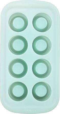 an ice tray with six circles on the bottom and four holes in the middle that are empty