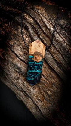 a piece of wood sitting on top of a wooden table next to a black cord