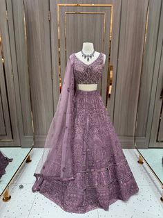 Our stunning Net Fabric Party Wear Lehenga in striking purple is perfect for making a bold statement at any special occasion, featuring intricate embroidery work in gold and silver threads. Dark Orchid, Party Wear Lehenga, Net Fabric, Intricate Embroidery, Bridal Lehenga, Embroidery Work, Model Dress, Gold And Silver, Lehenga