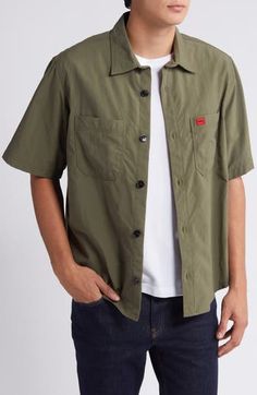 Lightweight, lightly rumpled nylon styled in a mossy green makes a warm-weather favorite of a shirt that looks best when you leave it untucked on sunny days. Front button closure Spread collar Short sleeves Chest patch pockets 100% nylon Machine wash, line dry Imported Solid Utility Top With Button Closure, Khaki Collared Camp Shirt For Outdoors, Khaki Outdoor Shirt With Button Closure, Solid Outdoor Shirt With Buttons, Solid Buttoned Shirt For Outdoor, Khaki Buttoned Tops For Outdoor, Collared Olive Shirt With Button Closure, Casual Khaki Shirt With Patch Pockets, Green Button-up Top With Patch Pockets