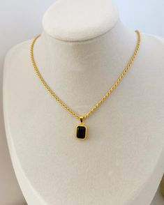 This black onyx pendant NECKLACE features a twist of gold rope chain and black onyx gemstone said to enhance clarity and sensibility. Giving any look a timeless sophistication, this black pendant necklace is the perfect addition for any night out stack. 18k gold plated sterling silver black gemstone with emerald cut pendant size 13mm x 10mm chain measures 45cm in length water resistant, hypoallergenic & nickel free packaged in ILLÁRI drawer jewelry box Gold Onyx Round Pendant Jewelry, Elegant Yellow Gold Onyx Necklaces, Luxury Black Rectangular Pendant Jewelry, Yellow Gold Onyx Pendant Necklace, Luxury Black Onyx Necklace, Luxury Yellow Gold Onyx Necklace, Drawer Jewelry, Black Pendant Necklace, Gold Pendent