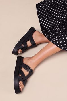 Create looks that are always chic and ready for fun with the Lulus Surie Black Strappy Flatform Slide Sandals! Smooth faux leather shapes these must-have sandals that feature an almond-shaped footbed and a cage-style upper composed of crisscrossing straps and an adjustable vamp strap that secures with a silver buckle detail. A .5"" contoured insole and a trendy flatform sole complete the sleek slide-on design! Available in whole sizes only. 1" flatform sole. Lightly cushioned contoured insole. R Chic Footbed Sandals With Heel Strap And Round Toe, Chic Strappy Sandals With Cushioned Footbed, Chic Closed Toe Cushioned Footbed Sandals, Chic Spring Footbed Sandals With Heel Loop, Trendy Strappy Synthetic Sandals, Strappy Sport Sandals With Buckle Closure For Summer, Trendy Platform Footbed Sandals, Chic Flat Cushioned Footbed Sandals, Trendy Flat Platform Footbed Sandals